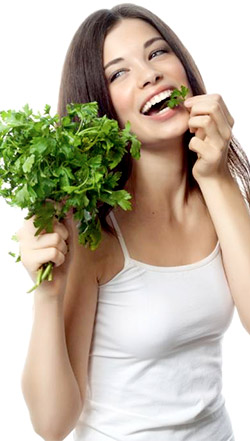 Slender girl eating parsley